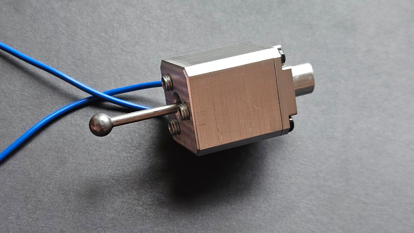Metallic sensor with blue cable on a gray background